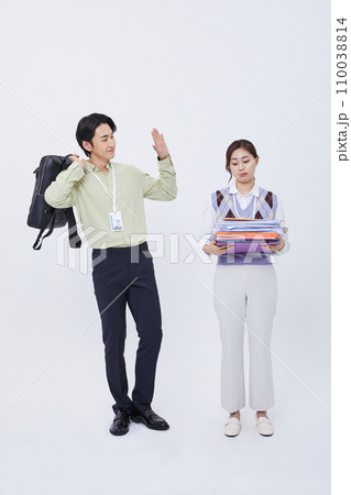 man leaving work greeting a woman holding a lot of documents man leaving work greeting a woman holding a lot of documents 110038814