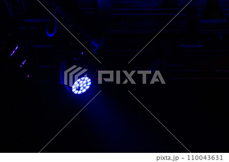 Stage LED spot light with blue beam in the dark 110043631
