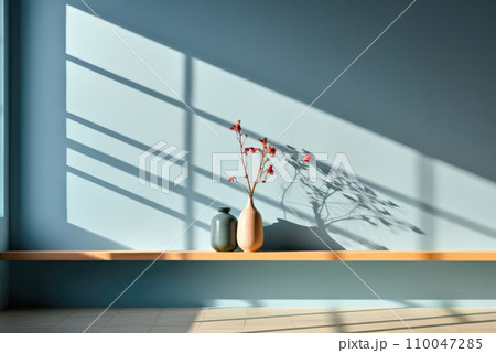Ceramic vases on a wooden bench, a sunny shadow on the blue wall Ceramic vases on a wooden bench, a sunny shadow on the blue wall 110047285
