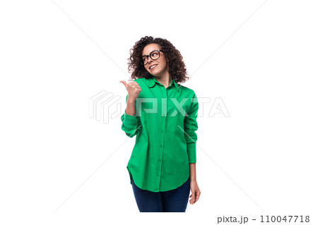 portrait of a brunette young caucasian lady with curly hair dressed in a green shirt 110047718