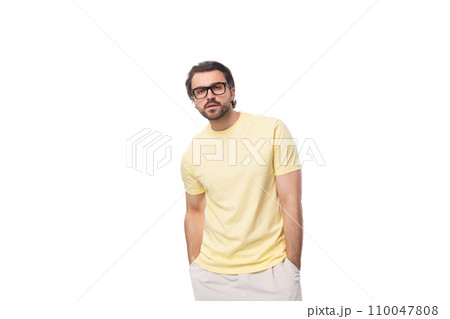 young smart brunette man with a black beard and mustache in glasses stands thoughtfully young smart brunette man with a black beard and mustache in glasses stands thoughtfully 110047808