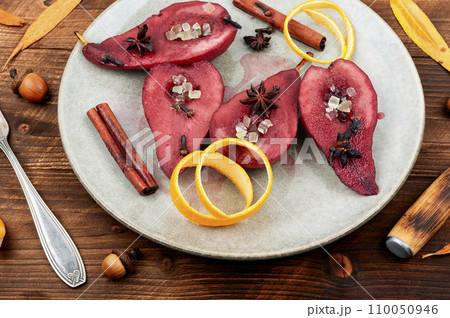 Sweet poached pears in red wine 110050946