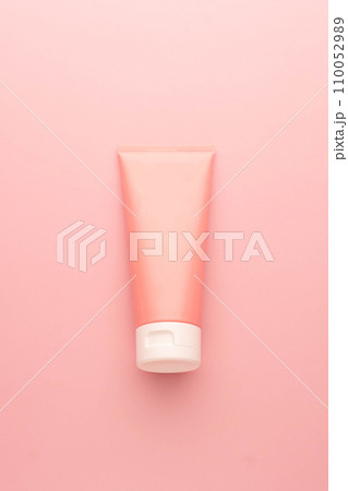 Blank pink squeeze bottle plastic tube on pink background. Packaging of cream, lotion, gel, facial foam or skincare. Cosmetic beauty product branding mock-up. Vertical. 110052989
