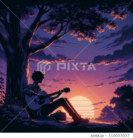 夕暮れ時木の下でギターを弾く男の人 110053057