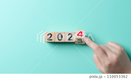 Countdown end of 2023, Start of 2024 Year. Schedule calendar strategy future vision, Business startup plan resolution 2024 Year, Hand touching wooden block on light blue background, New Year concept. 110053362