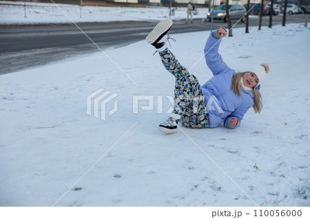 A woman fell over on an un-snowed sidewalk in the city. 110056000