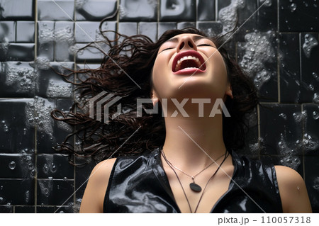 Young european woman having orgasm. Woman with open mouth and closed eyes enjoying sex lying on wet tiled floor in a shower, screaming in passion. Sexual experience, masturbation, cunnilingus. 110057318
