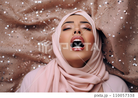 Young muslim woman having orgasm. Beautiful woman with open mouth and closed eyes enjoying sex lying among fireworks. Sparklers as a symbol of orgasm. Sexual experience, masturbation, cunnilingus. Young muslim woman having orgasm. Beautiful woman with open mouth and closed eyes enjoying sex lying among fireworks. Sparklers as a symbol of orgasm. Sexual experience, masturbation, cunnilingus. 110057338