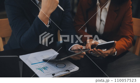 Entrepreneur Asian businessman and businesswoman discussing new business project in tablet in modern Meeting In Modern Office, Asian business casual concept. 110057523