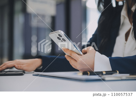 Financial analysts analyze business financial reports on a digital tablet planning investment project during a discussion at a meeting of corporate showing the results of their successful teamwork. 110057537