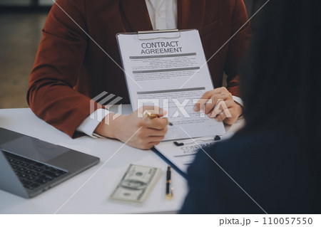 Lawyer, legal advisor, businessman brainstorming information on agreement details Business contracts in legal processing books for accuracy in contract documents. joint financial investment. 110057550