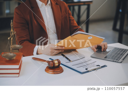 Lawyer, legal advisor, businessman brainstorming information on agreement details Business contracts in legal processing books for accuracy in contract documents. joint financial investment. 110057557
