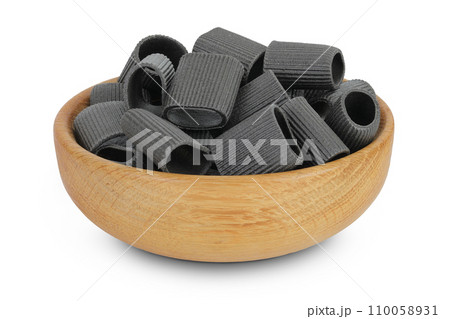 Black pasta with cuttlefish ink in wooden bowl isolated on white background 110058931
