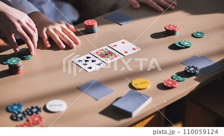 Young guys playing poker at a table. Young guys playing poker at a table. 110059124