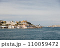 Exiting the port of Marseille into the sea, view of the green lighthouse. 110059472