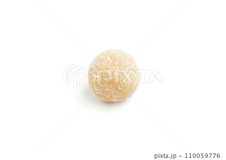 Typical Brazilian sweet brigadeiro. One coconut candy on a white background 110059776