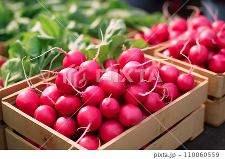 AI-generated content. Bright pink radishes with delicate roots nestle among vibrant green leaves in a wooden box, presenting a picture of freshness and springtime harvest. 110060559