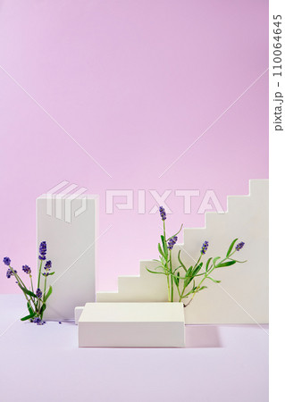 The white platforms are artistically arranged with lavender flowers on a pastel purple background. Empty space for product display. Front view. 110064645
