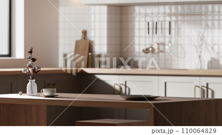 A bright beige-toned kitchen interior with sunlight coming through the window. A bright beige-toned kitchen interior with sunlight coming through the window. 110064829