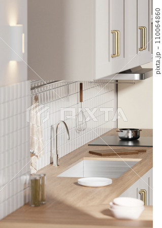 A bright beige-toned kitchen interior with sunlight coming through the window. 110064860