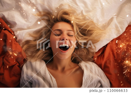 Young blonde woman having orgasm. Beautiful woman with open mouth and closed eyes enjoying sex lying among fireworks. Sparklers as a symbol of orgasm. Sexual experience, masturbation, cunnilingus. 110066633