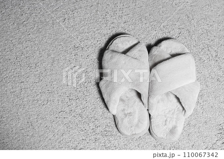 Modern Stylish Fluffy Grey House Slippers On Carpet, Top View, Space For Text. Modern Stylish Fluffy Grey House Slippers On Carpet, Top View, Space For Text. 110067342
