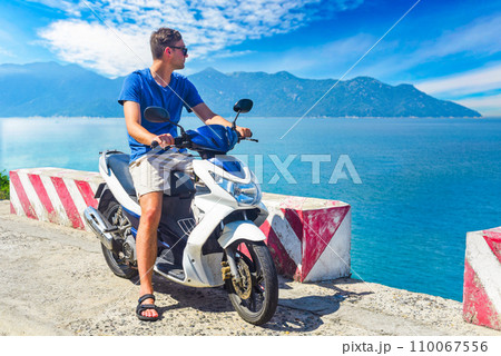 Young man motorbike driver driving in Vietnam Young man motorbike driver driving in Vietnam 110067556