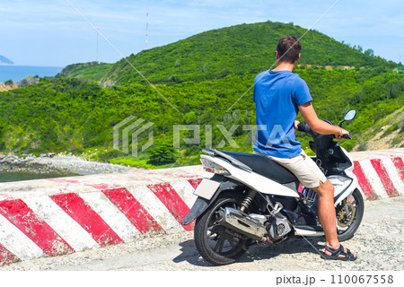 Young man motorbike driver driving in Vietnam Young man motorbike driver driving in Vietnam 110067558
