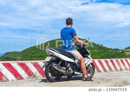 Young man motorbike driver driving in Vietnam Young man motorbike driver driving in Vietnam 110067559