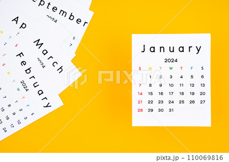 Calendar page for January 2024 on yellow background. Calendar page for January 2024 on yellow background. 110069816