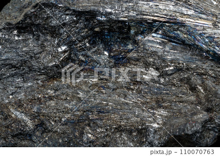 Macro of a stone Stibnite mineral on a black background 110070763