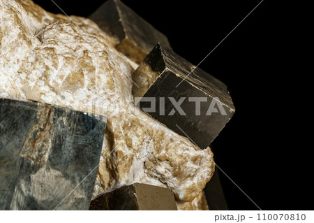 Macro stone Pyrite mineral in rock on a black background 110070810