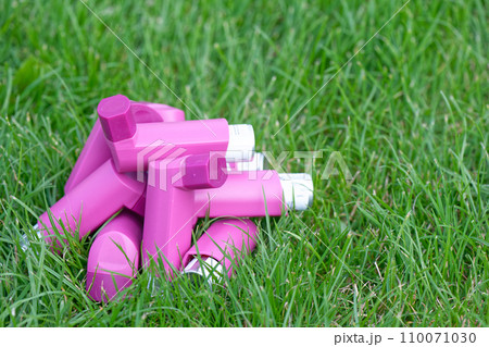Asthma inhalers on a green grass meadow Asthma inhalers on a green grass meadow 110071030