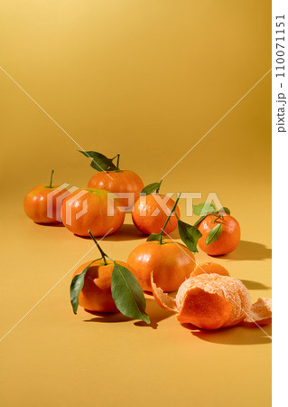 Plump tangerines are displayed on a yellow background. This is a fruit that symbolizes Tet, containing a lot of vitamin C that is good for the skin and body. Plump tangerines are displayed on a yellow background. This is a fruit that symbolizes Tet, containing a lot of vitamin C that is good for the skin and body. 110071151