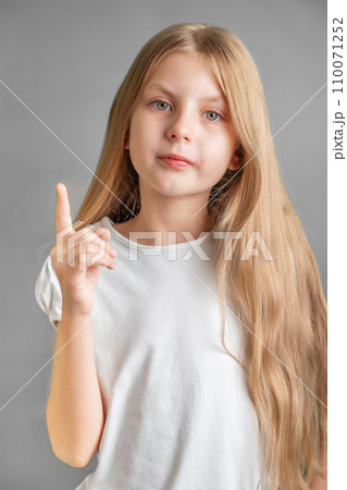 Adorable little girl direct finger up Adorable little girl direct finger up 110071252
