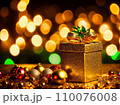 Christmas gift box with golden baubles on bokeh background 110076008