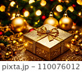 Christmas gift box with golden baubles on bokeh background 110076012