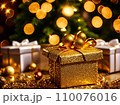 Christmas gift box with golden baubles on bokeh background 110076016