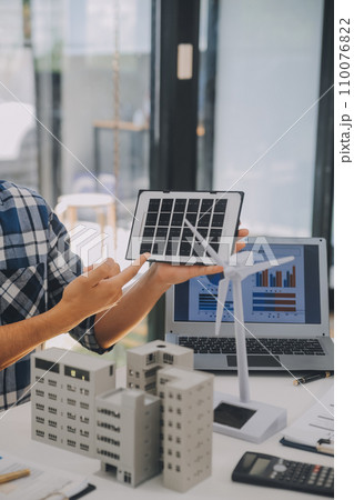 Electrical engineer with businessman discussing new project installation solar cell panel on the roof of building. Alternative energy concept. Electrical engineer with businessman discussing new project installation solar cell panel on the roof of building. Alternative energy concept. 110076822