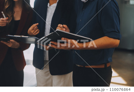 Group of Young Asian business team creative businesspeople coworker in office Happy to be successful partnership teamwork celebrating achievement and success concept. 110076864