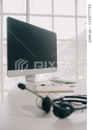 Communication support, call center and customer service help desk. VOIP headset on telephone keyboard. Communication support, call center and customer service help desk. VOIP headset on telephone keyboard. 110077748