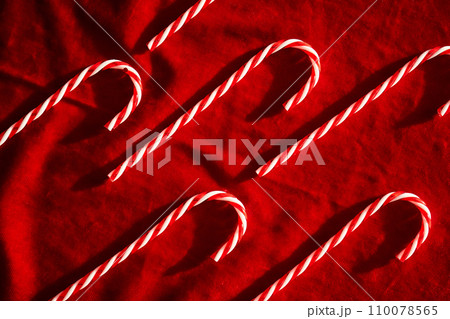 Christmas candy canes on burgundy velvet background. 110078565