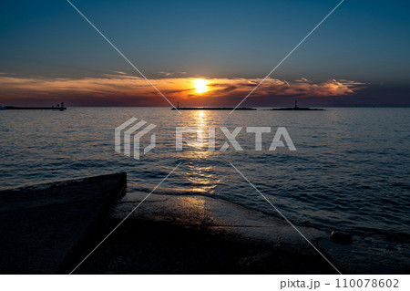 Sunset Over The Mediterranean Sea At The Beach Of The City Porec In Croatia 110078602