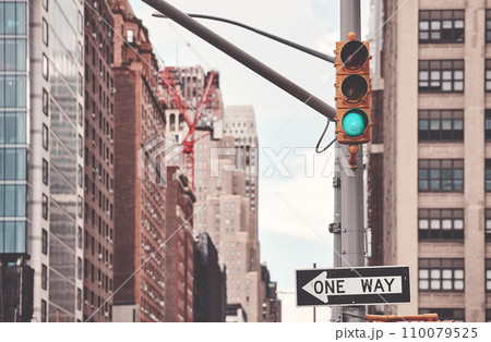 One Way road sign and traffic lights in New York City, color toning applied, selective focus, USA. 110079525