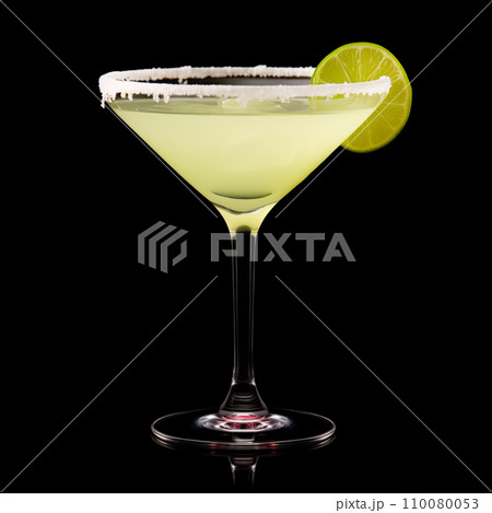 Margarita cocktail in salt-rimmed glass with lime isolated on black background Margarita cocktail in salt-rimmed glass with lime isolated on black background 110080053