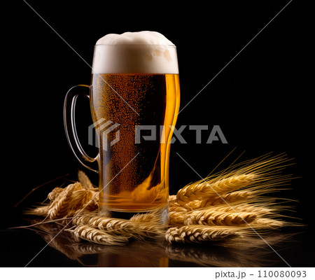 Beer in mug with wheat ears spikelets on black background. Mugs with drink like Ipa, Pale Ale, Pilsner, Porter or Stout 110080093