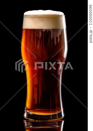 Beer in a tall glass on a dark black background. Mugs with drink like Ipa, Pale Ale, Pilsner, Porter or Stout Beer in a tall glass on a dark black background. Mugs with drink like Ipa, Pale Ale, Pilsner, Porter or Stout 110080096