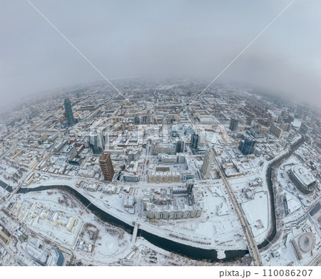 Yekaterinburg aerial panoramic view at Winter in cloudy day. Ekaterinburg is the fourth largest city in Russia located in the Eurasian continent on the border of Europe and Asia. Yekaterinburg aerial panoramic view at Winter in cloudy day. Ekaterinburg is the fourth largest city in Russia located in the Eurasian continent on the border of Europe and Asia. 110086207