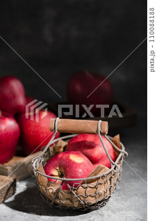 red apples in a wicker basket on dark background red apples in a wicker basket on dark background 110088188