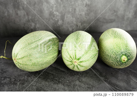 Fresh honeydew melon on dark background Fresh honeydew melon on dark background 110089879